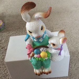 Momma and baby bunnies sit on edge of shelf